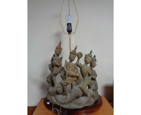 A carved oriental style figural table lamp  