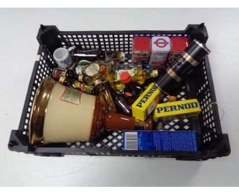 A basket of alcohol miniatures and a Bells whiskey decanter 