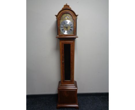 A continental granddaughter clock with moonphase dial 