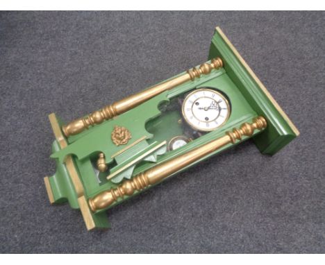 An early 20th century painted cased wall clock, with pendulum and key 