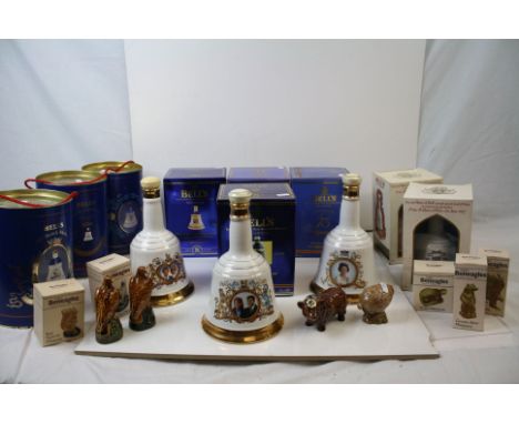 A large collection of Bell's Whisky ceramic commemorative decanters to include boxed examples together with a quantity of Gol