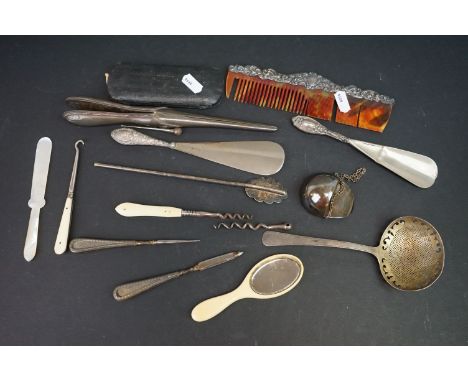 A group of mixed collectables to include a hallmarked sterling silver topped comb, button hook and shoe horn together with si