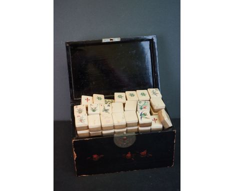 A early 20th century mahjong set in a paper mâché box. 