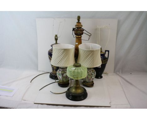 A group of five ceramic table lamps together with an oil lamp base. 