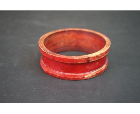 An African traders bangle c.1850, the ivory bangle stained red and faintly inscribed. 