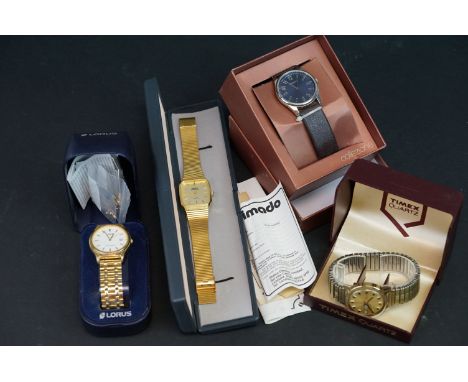 A collection of four boxed gents watches to include Timex and Lorus. 