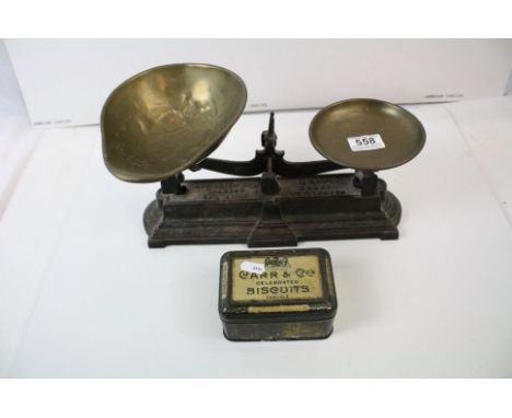 A set of cast iron kitchen scales complete with weights and brass pans. 