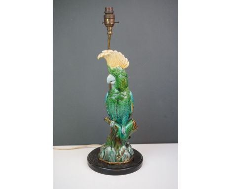 A table lamp in the form of a Majolica Cockatoo mounted on a wooden base 51 cm to top of bulb holder. 