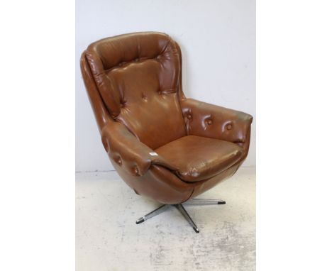 Mid 20th century Tan Button Back Egg Chair raised on a chrome swivel base, 98cms high x 80cms wide 
