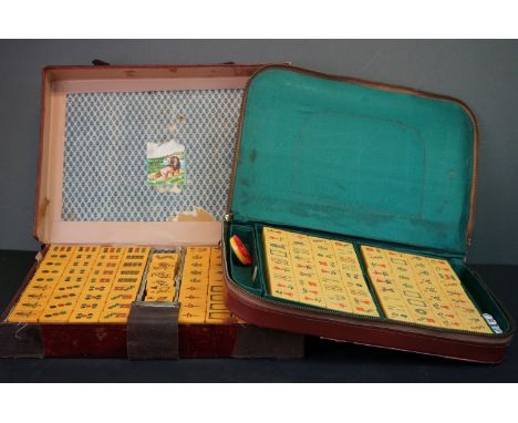 Two leather cased Mahjong sets together with a leather cup holder and a group of vintage penknives. 