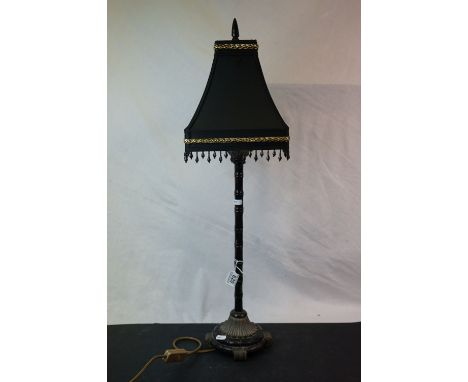 A bamboo style table lamp with black shade. 