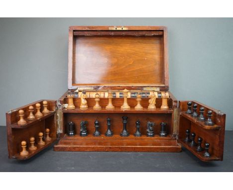 A wooden cased games compendium to include Chess, Draughts, Bezique and cribbage. 