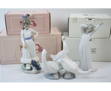 A collection of four boxed Nao ceramic ornaments to include Female figures and geese. 