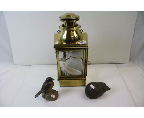 A brass lantern with glass panels together with two ceramic animal figures. 