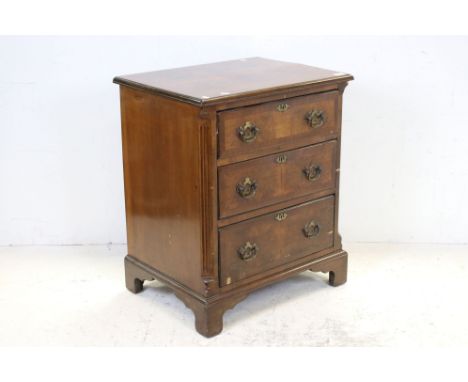 George III Walnut and Burr Walnut Chest of Three Drawers, of small proportions, with canted corners and raised on bracket fee