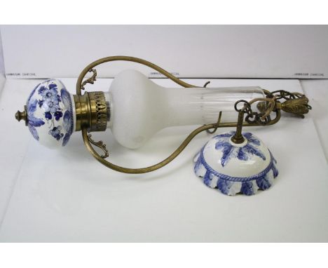 A antique gilt metal and ceramic ceiling light with blue and white floral decoration. 