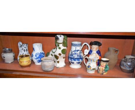 A Caughley cabbage leaf jug, c.1780; a Medieval pottery jug and jar; other jugs; Toby jugs; a Staffordshire dog; all a/f (12)
