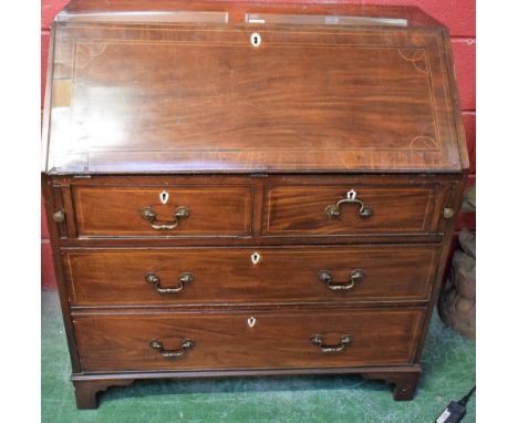 A George III mahogany bureau, fall front enclosing pigeon holes and small drawers above two short and two long graduated cock
