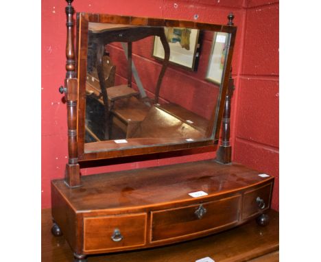 An Edwardian mahogany dressing mirror, adjustable rectangular plate, ring turned supports, above three frieze drawers, ball f