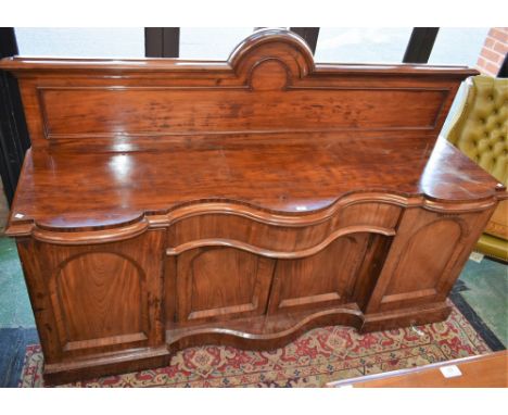 A substantial Victorian mahogany sideboard, shaped serpentine top with bold half gallery above a frieze drawer and a pair of 