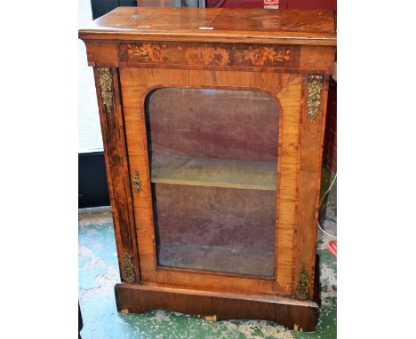 A gilt metal mounted marquetry pier cabinet, rectangular top above a concave frieze inlaid with flowers and C-scrolls, and a 