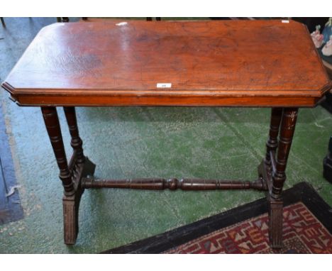 A late Victorian/Edwardian mahogany centre table, moulded chamfered rectangular top, ring turned supports and stretcher, flut