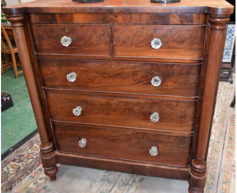 A Victorian mahogany 'Scotch' chest, hipped rectangular top above two short and three long cockbeaded drawers flanked by near