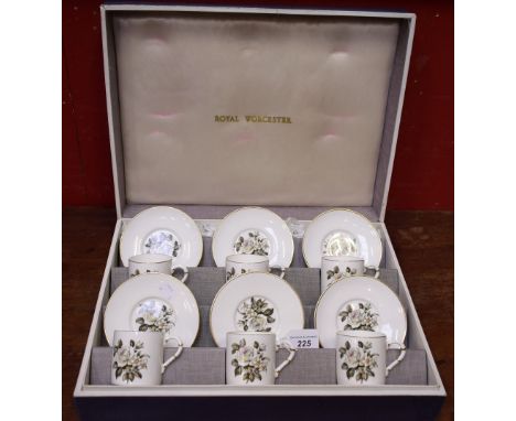 A Royal Worcester set of six coffee cans and saucers, White Rose pattern, original Royal Worcester fitted box