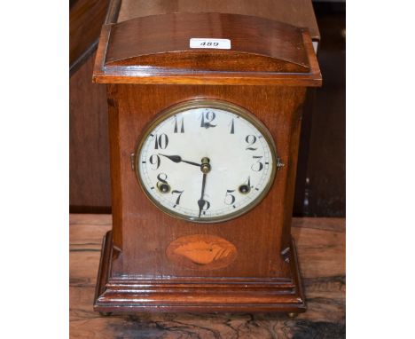A Edwardian mahogany inlaid mantel clock, central shell patera, circular dial, Arabic numerals, eight day movement, twin wind