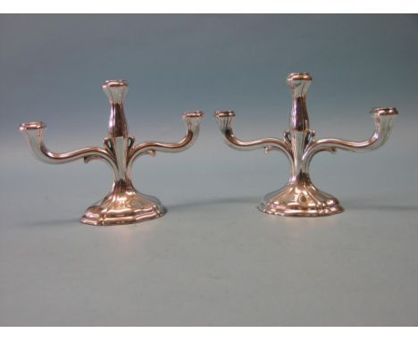 A pair of imported silver candelabra, three sconces, oval bases, one stamped .925, the other .835, 8.5in. - loaded, approx. 2