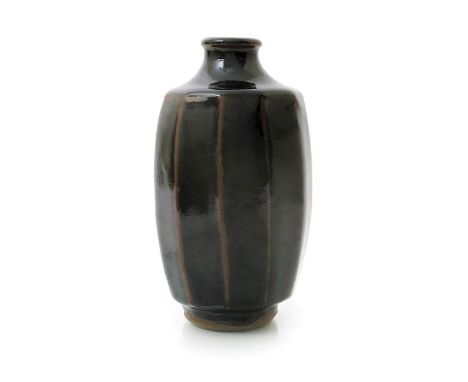 ‡ Geoffrey Whiting (1919-1988) an Avoncroft cut-sided stoneware bottle vase, covered to the foot in a rich tenmoku glaze, sea