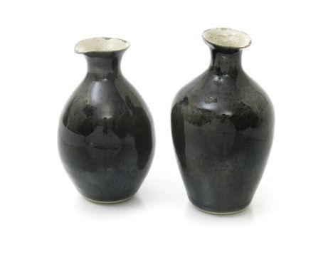 ‡ Dame Lucie Rie DBE (1902-1995) a pair of stoneware pouring jars, each covered with a blue speckled glazed over grey, impres