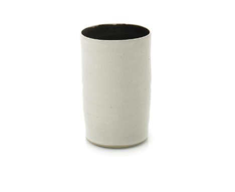 ‡ Dame Lucie Rie DBE (1902-1995) a stoneware cylindrical vase, covered with a glossy off-white glaze to the exterior, the int
