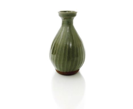 ‡ Bernard Leach (1887-1979) a stoneware vase, spiralling faceted form covered to the foot in a celadon glaze impressed seal m