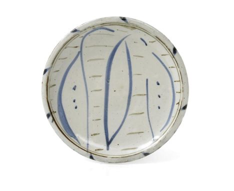 ‡ Michael Cardew (1901-1983) a Wenford Bridge pottery plate, tin-glazed, painted with blue wave and leaf design, impressed se
