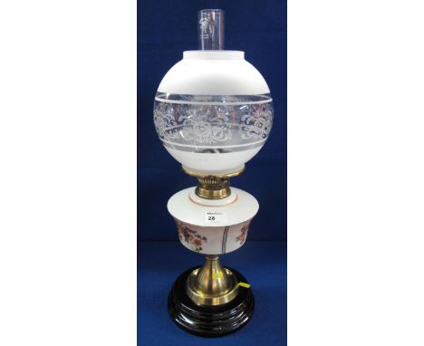 Early 20th Century brass double burner oil lamp with floral decorated reservoir on brass pedestal with ceramic base, etched g