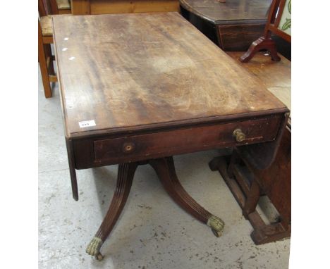 19th Century mahogany sofa table on brass claws and casters.