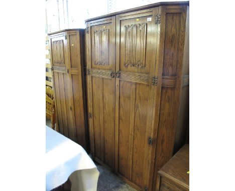 Mid 20th Century oak 'Old Charm' bedroom suite comprising double and single wardrobes, mirror back dressing table and bed end