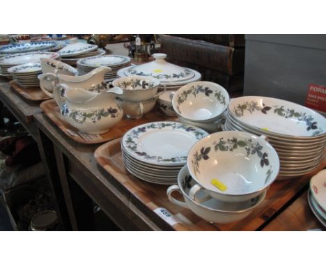 Four trays of Royal Doulton 'Burgundy' dinnerware items to include: two handled bowls; various plates; cereal bowls; tureens;