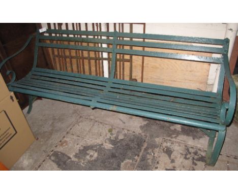 Heavy wrought iron garden bench. CONDITION REPORT: Some rusting in places. Side scroll arm is detached from back rail. 
185cm