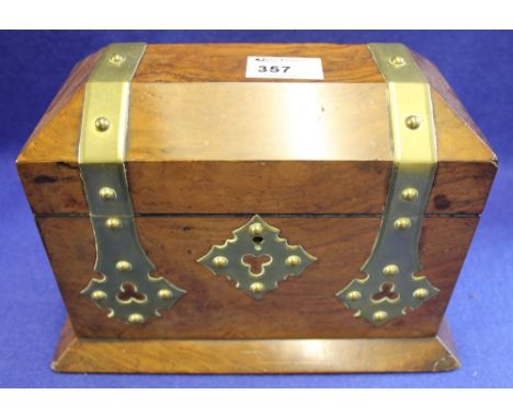 Victorian Gothic design, walnut, brass mounted tea caddy of sarcophagus form with two lidded compartments to the interior.