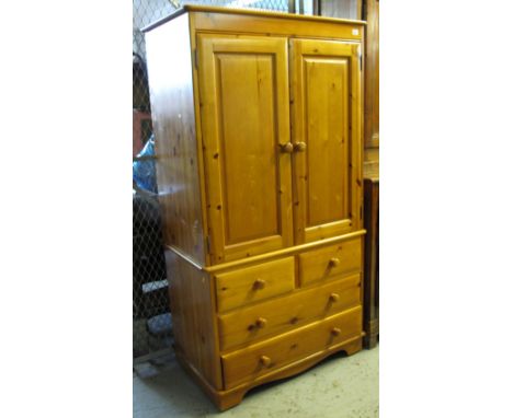 Modern natural pine 'Lovelace Country Furniture' wardrobe, having two short and two long drawers on bracket feet.