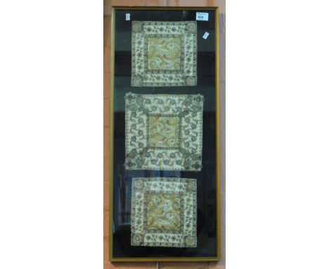 Three needlepoint foliate panels with paisley print centres, in a single frame.  Late 19th/early 20th Century.