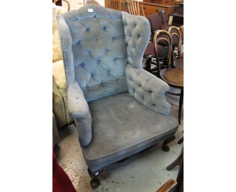 Early 20th Century button back upholstered wing chair.