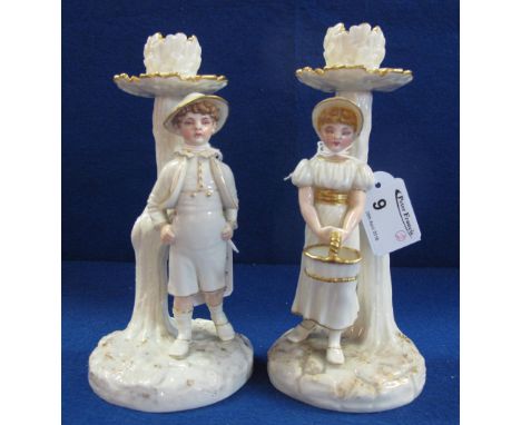 Pair of Royal Worcester James Hadley 1886 porcelain figural candlesticks with painted features and gilded highlights, arborea