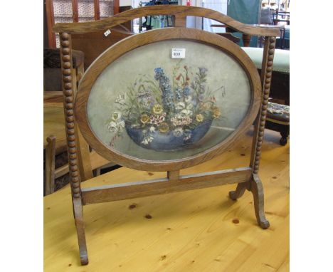 Oak framed tapestry fire screen with bobbin turned decoration.