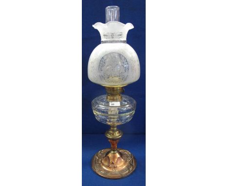 Early 20th Century brass double burner oil lamp, having thumb cut clear glass reservoir on a Art Nouveau design brass pedesta