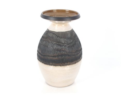 A Poole pottery vase by Guy Sydenham, having raised bark effect decoration on a cream ground, brown glazed flared neck, 33cm 