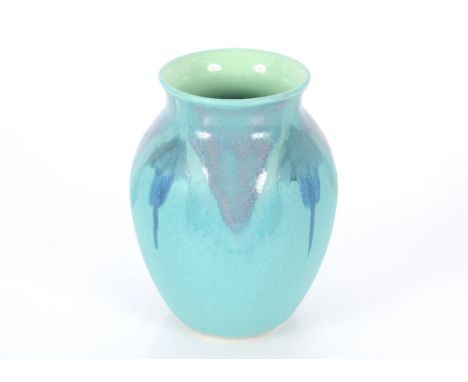 A Poole pottery baluster vase, having pale blue running glaze decoration, 20cm high 