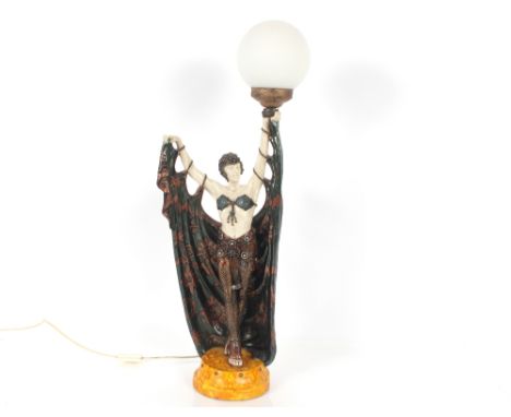 An Art Deco style table lamp in the form of a dancing girl with opaque globe shade, 79cm high overall